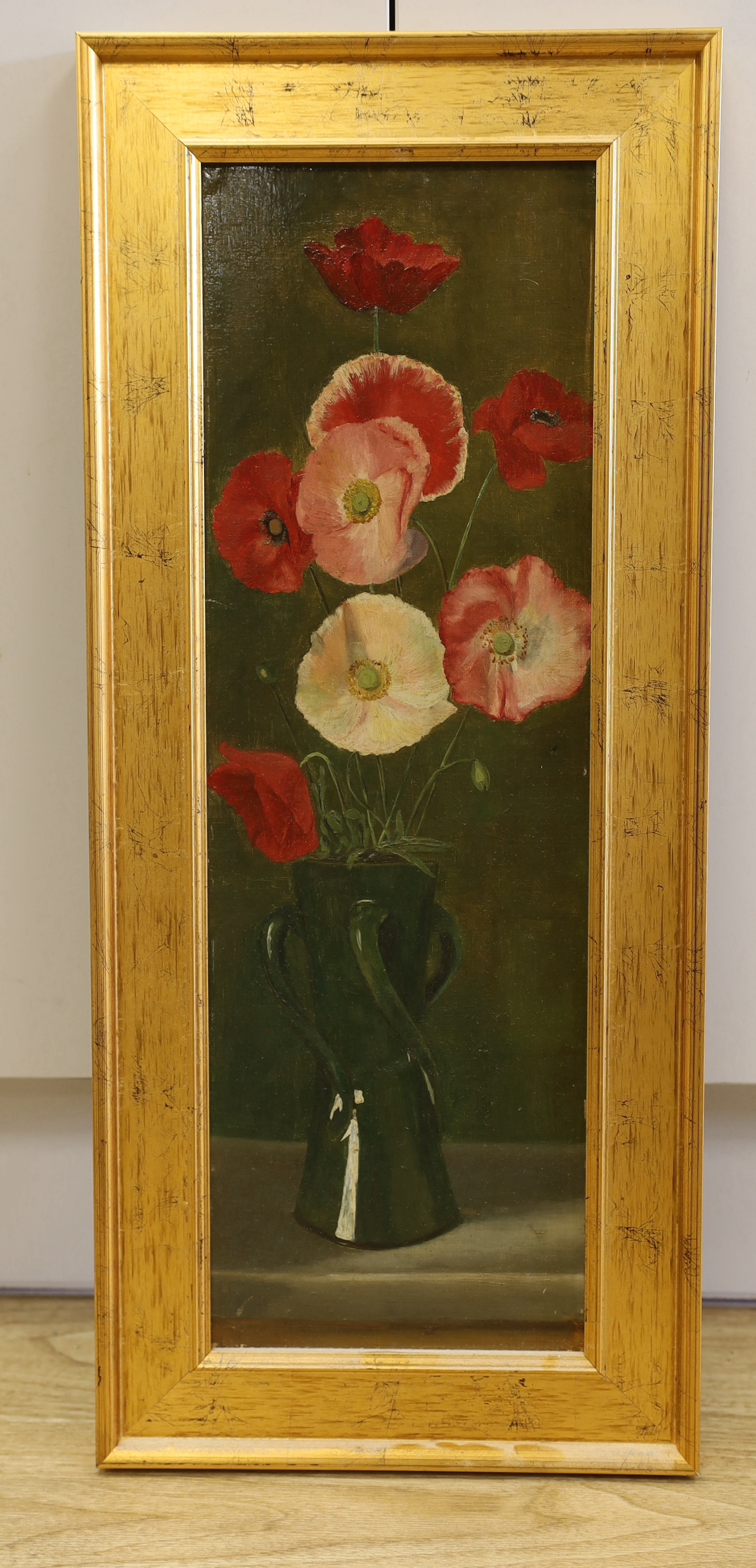 English School c.1920, oil on board, Still life of poppies in an art pottery vase, 56 x 18cm